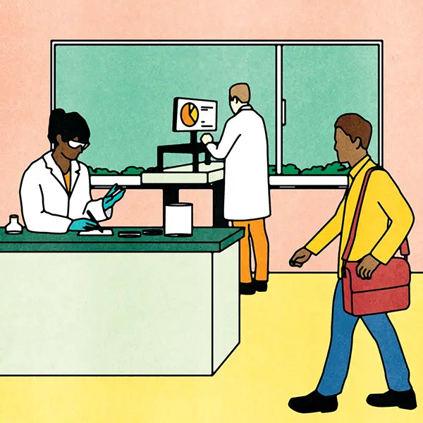 Two researchers work in a lab while a student with a red bag walks past.