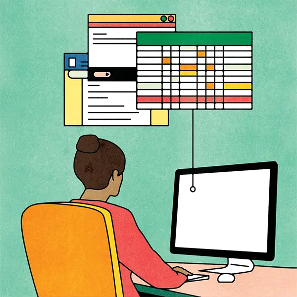 Administrator working on a computer with spreadsheets and database files shown above.